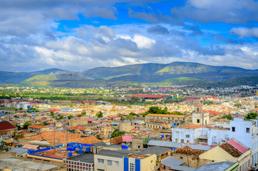 Fototapeta na wymiar aerial view of the old Cuban city bordered by mountains, beautiful clouds in the sky