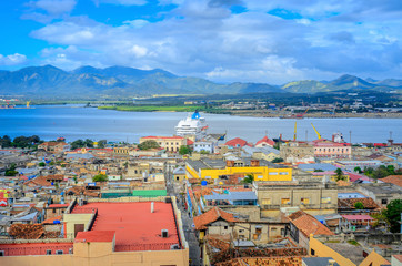 view from the air to the old Cuban port city, a large cruise liner stands at the pier