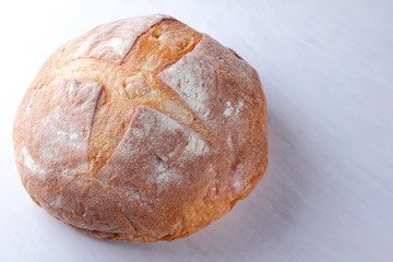 Bread baked in wood stove, white bread on white background, golden crust, bread bakery for designer, agriculture, wheat flour, white wooden background, food, French cuisine