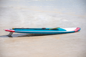 Paddleboard is laying over the ocean