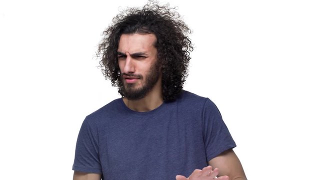 Portrait of caucasian unhappy man in casual clothing expressing rejection with disgust on his face, over white background. Concept of emotions