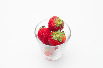 Strawberries in a glass on white bakcground 