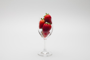 Ripe strawberries in a wine glass isolated 