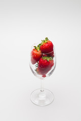 Ripe strawberries in a wine glass isolated 