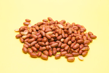 Pile of peanut on yellow background 