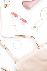 Pale pastel pink female accessory collection on white background. Flat lat, top view of sunglasses, clutch, necklace, bracelet, watch. Minimal concept.