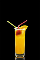 Orange juice in a high glass isolated on a black background