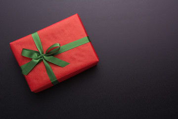 Hands holding wrapped gift box with colored ribbon as a present for Christmas, new year, mother's...