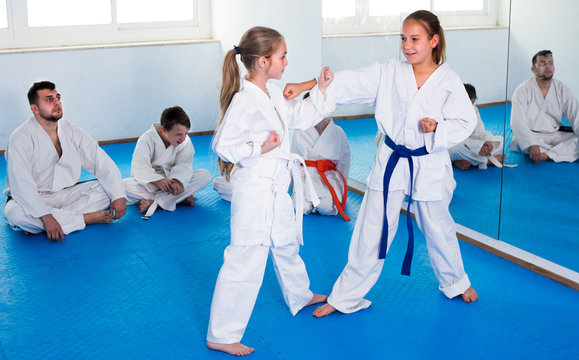 Pair of girls are trying in sparring to use new moves