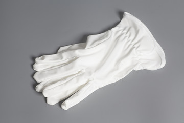 Fototapeta na wymiar White service gloves on gray background