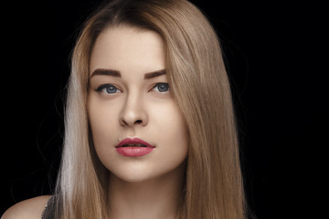 Close-up portrait of a beautiful girl with white hair and blue eyes and perfect skin. Everyday make-up, studio photo. isolated on a black background.