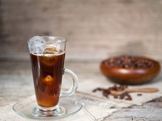 Iced coffee with ice on a wooden table