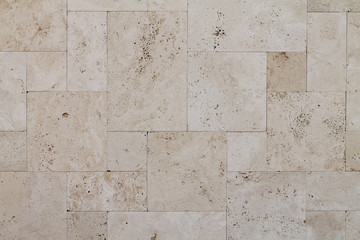 Natural Italian stone. Smooth travertine surface. A sample of wall cladding with natural stone.	