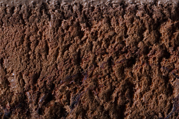 Surface of chocolate ice cream, sweet frozen dessert for summer breakfast. Photographed close-up.