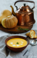 pumpkin cream soup, vintage style, old ceramic boul, rosmarin