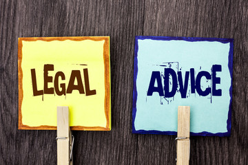 Word writing text Legal Advice. Business concept for Recommendations given by lawyer or law consultant expert written on Sticky Note Papers Holding with Wooden Clip on the wooden background.