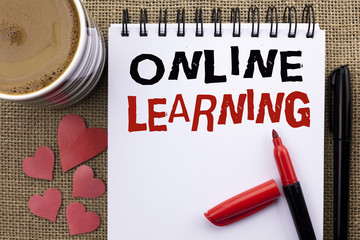 Conceptual hand writing showing Online Learning. Business photo showcasing Distance education Electronic educational Technology written on Notebook Book on the jute background Cup Hearts Pen