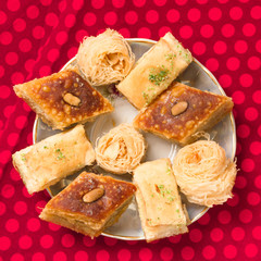 Oriental sweets on a dark red background.