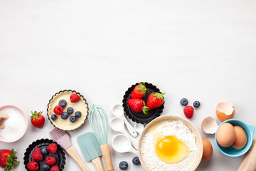 Baking utensils and cooking ingredients for tarts, cookies, dough and pastry. Flat lay with eggs,...