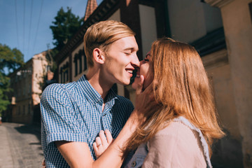 Naklejka premium young and beautiful guy and girl kiss each other on the street