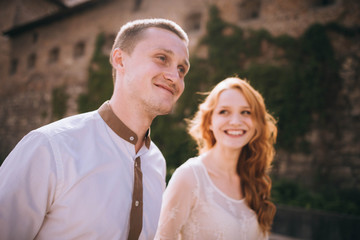 young and beautiful woman and man standing together on the street