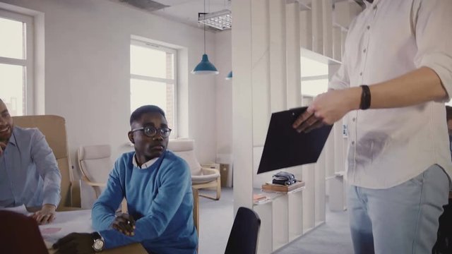 Young businessman using gyroscooter to move around the office. Confident business leader guides colleagues, close-up 4K.
