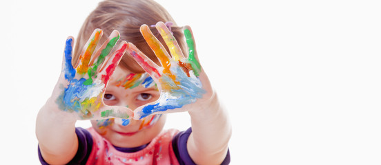Colorful painted hands in a beautiful young girl (art, childhood, color)