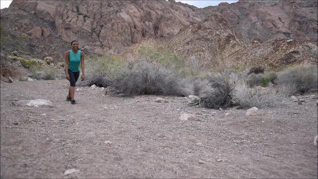 Woman getting ready to run in desert landscape