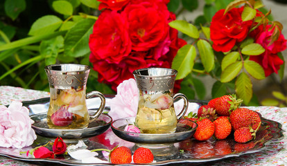 tea with rose petals, natural sunshine, outdoor 

