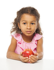 Portrait of a pretty little girl with a red apple
