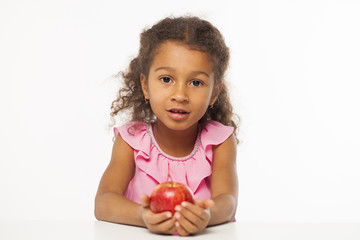 Portrait of a pretty little girl with a red apple