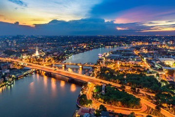 The beautiful of Bangkok city scape areas Phra Buddha Yodfa Bridge for communication between Chaopraya river the capital of Thailand in twilight dramatic sky.