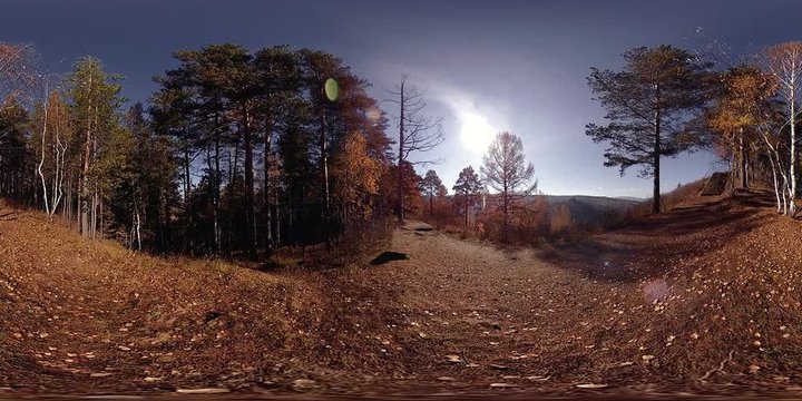 4K 360 VR virtual Reality of a beautiful mountain scene at the autumn time. Wild Russian mountains, pine forest and meadow. National park with paths and sun rays.