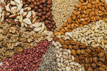Nuts mix in a canvas bag in table. Ten kinds of nuts: pecan, brazil, cedar, sunflower, hazelnut, almond, peanut walnut pistachio cashew