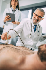 Fototapeta premium Ultrasound scanner in the hands of a doctor. Diagnostics. Sonography.
