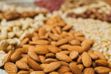 Nuts mix in a canvas bag in table. Ten kinds of nuts: pecan, brazil, cedar, sunflower, hazelnut, almond, peanut walnut pistachio cashew