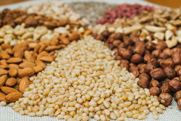 Nuts mix in a canvas bag in table. Ten kinds of nuts: pecan, brazil, cedar, sunflower, hazelnut, almond, peanut walnut pistachio cashew