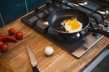 She cooks the scrambled eggs a frying pan in the kitchen. Breakfast for scrambled eggs