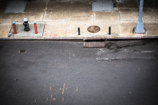 New York City, Manhattan Street Scene Viewed From Above With Sidewalk, Fire Hydrant And Manhole Drainage Seen From Chelsea.