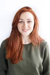 Obraz premium Portrait of a girl with red hair on a white background