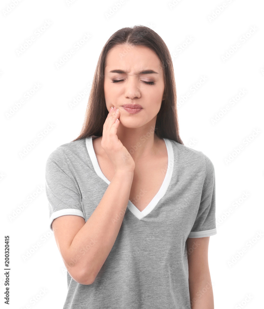 Wall mural young woman suffering from tooth ache on white background