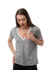 Young woman suffering from pain in chest on white background