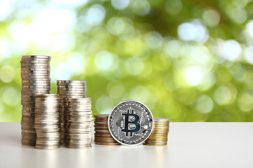 Silver coins placed on a white table. Green backdrop