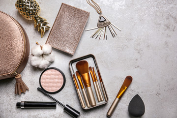Flat lay composition with professional makeup brushes on light background