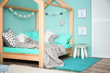 Comfortable bed in modern children room