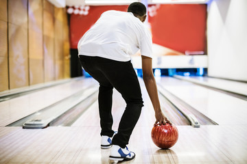 Boy about to roll a bowling ball hobby and leisure concept