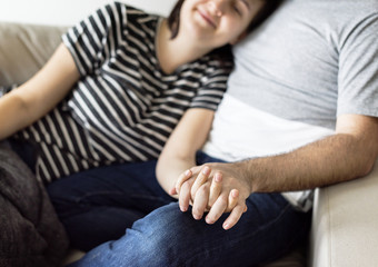 Happy couple relaxing at home