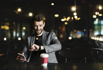 Casual man using mobile phone in the cafe