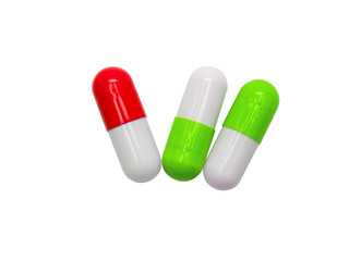 red, white, green medicine capsules isolated on white background. healthy medical product concept.