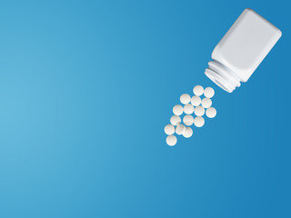 Pills spilling out of pill bottle and isolated with clipping path on red. Top view with copy space. Medicine concept